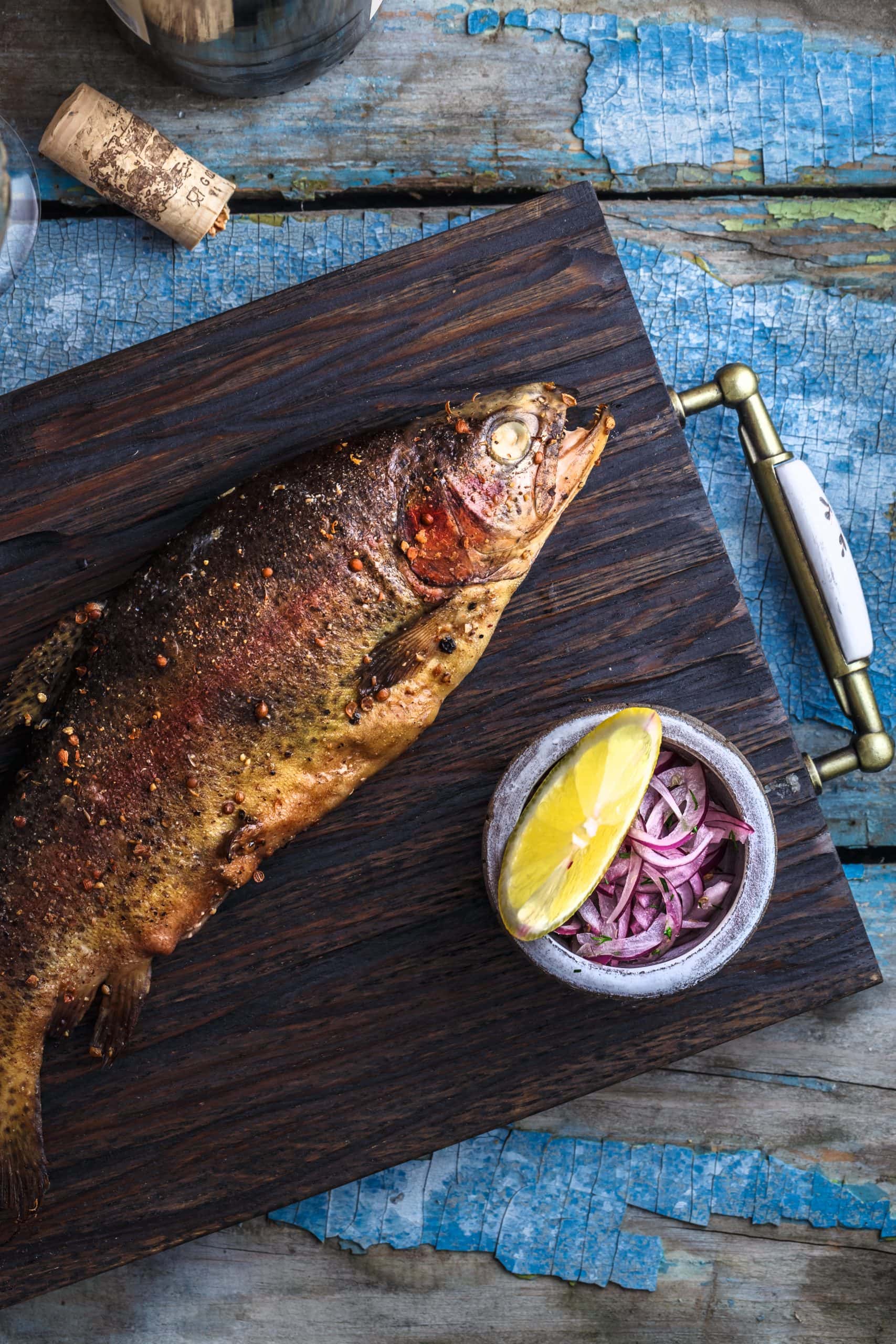 smoked whole trout on tray with coleslaw