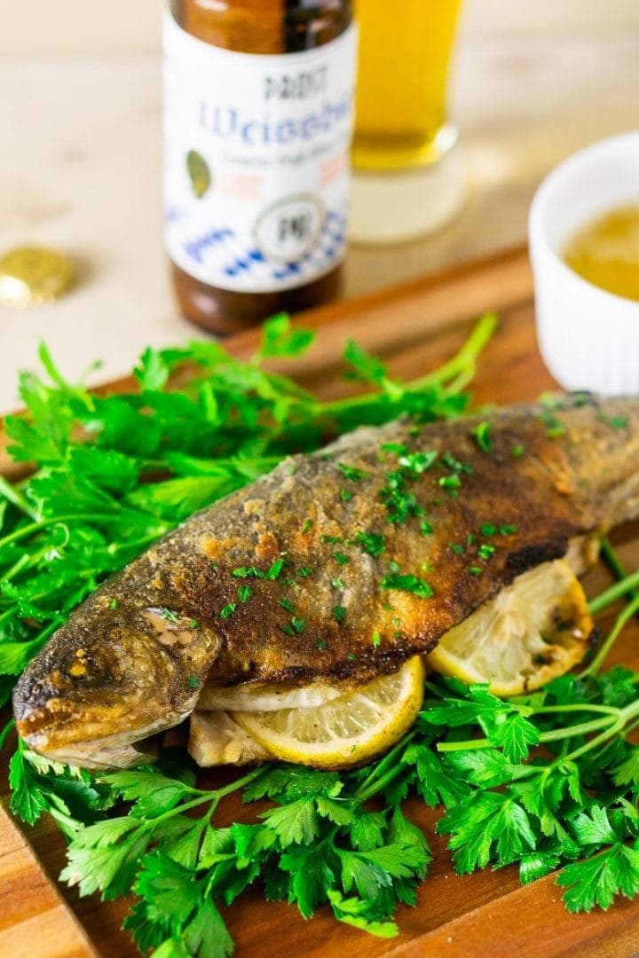 whole panfried trout fish with a german wheat beer