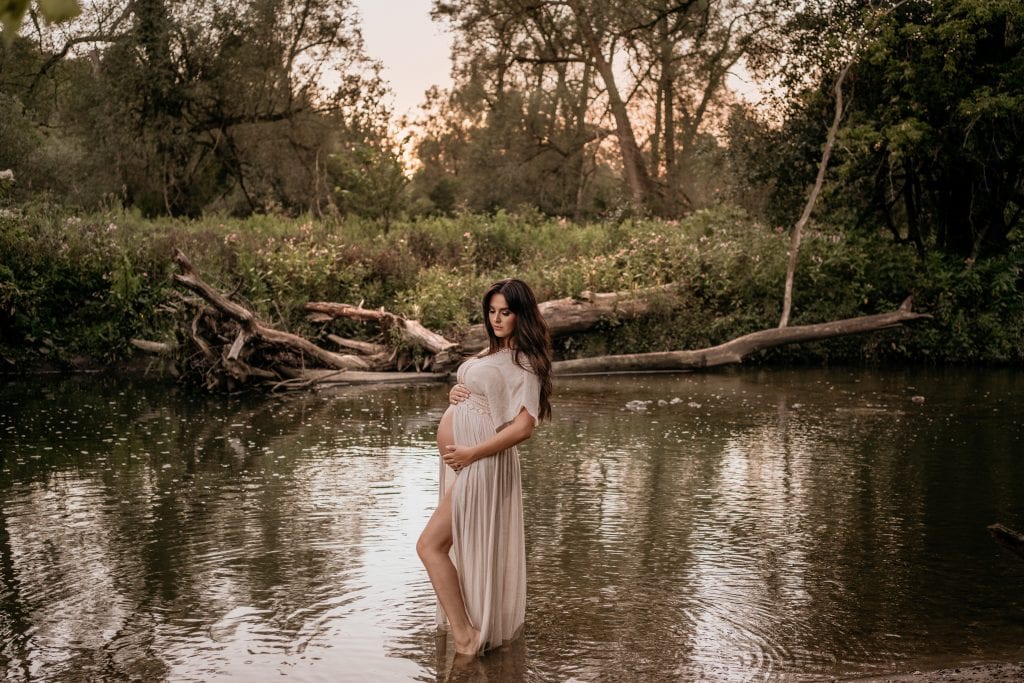 9 month pregnant woman (me) standing in river
