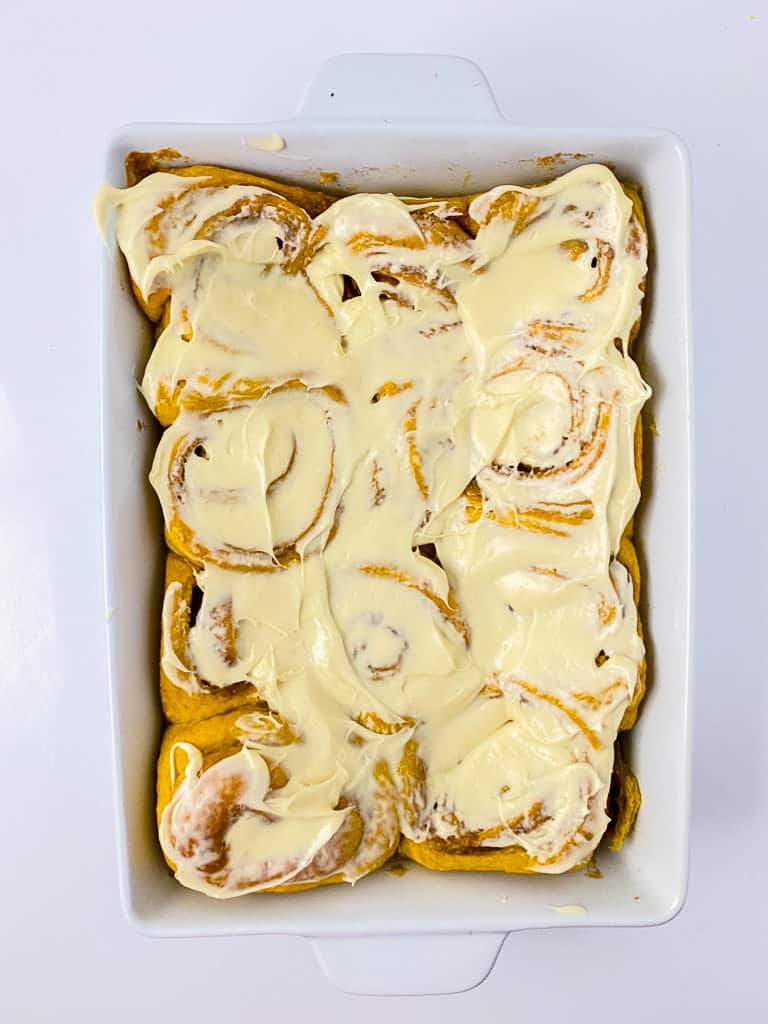 baked and cooled pumpkin rolls covered in icing
