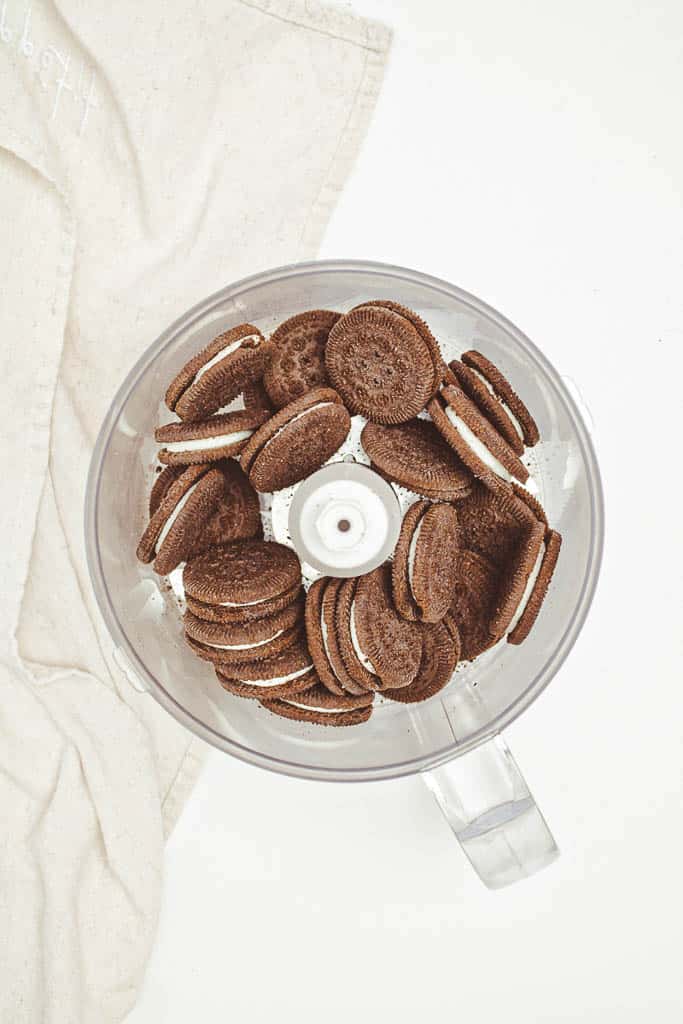 Whole cookies sitting in a food processor.
