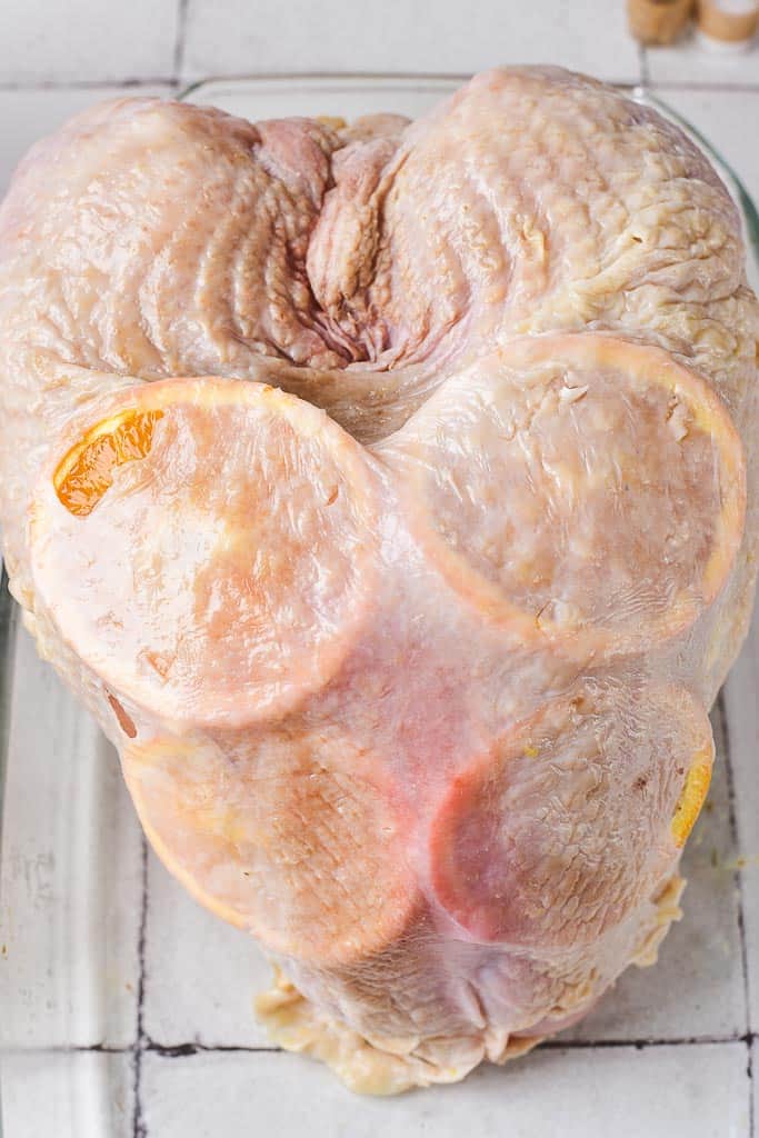 the raw crown roast breast with the skin pulled back down over the fresh orange slices