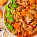 A large bowl of beef vegetable barley stew.