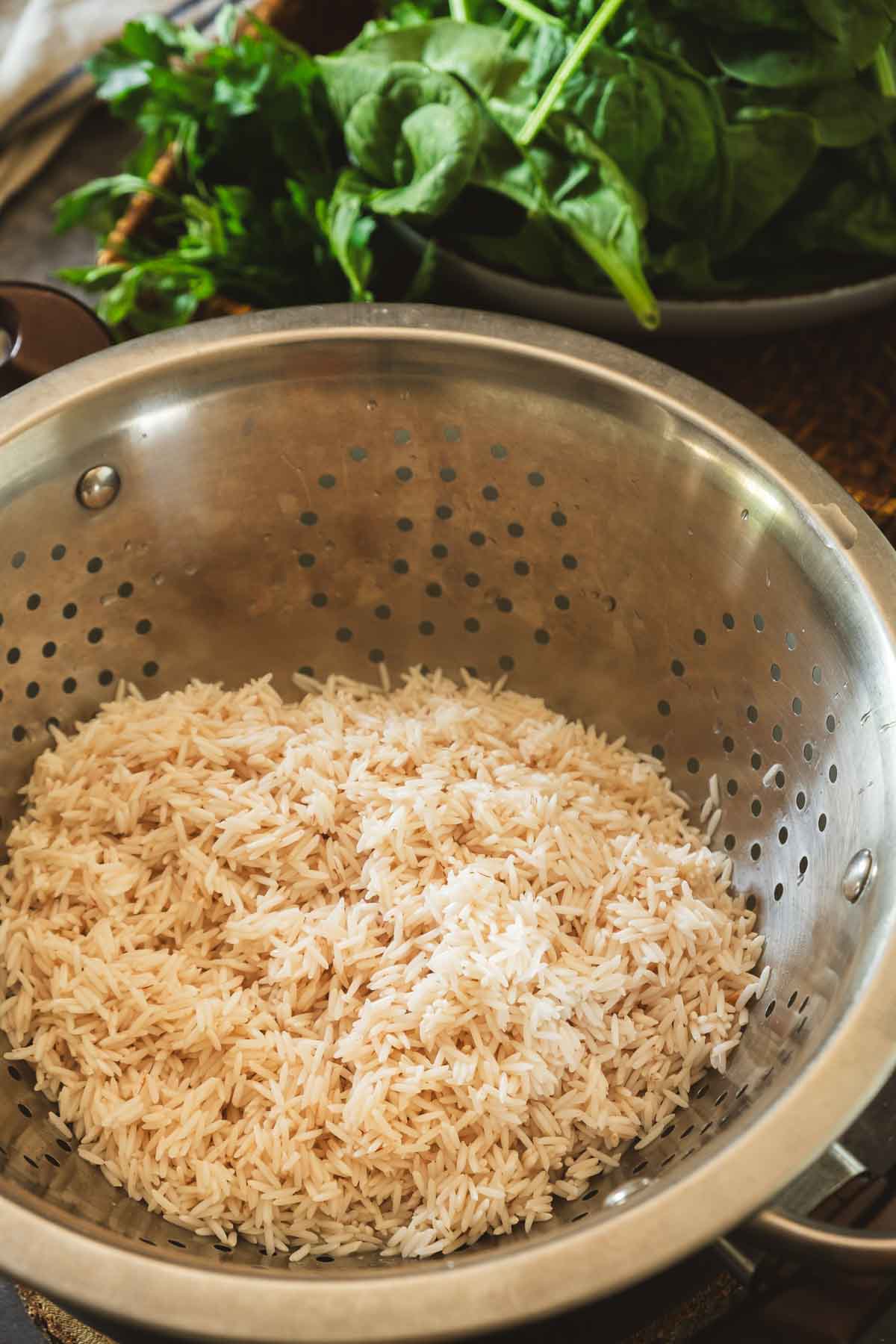 Basmati rice rinsed in a steel colander.
