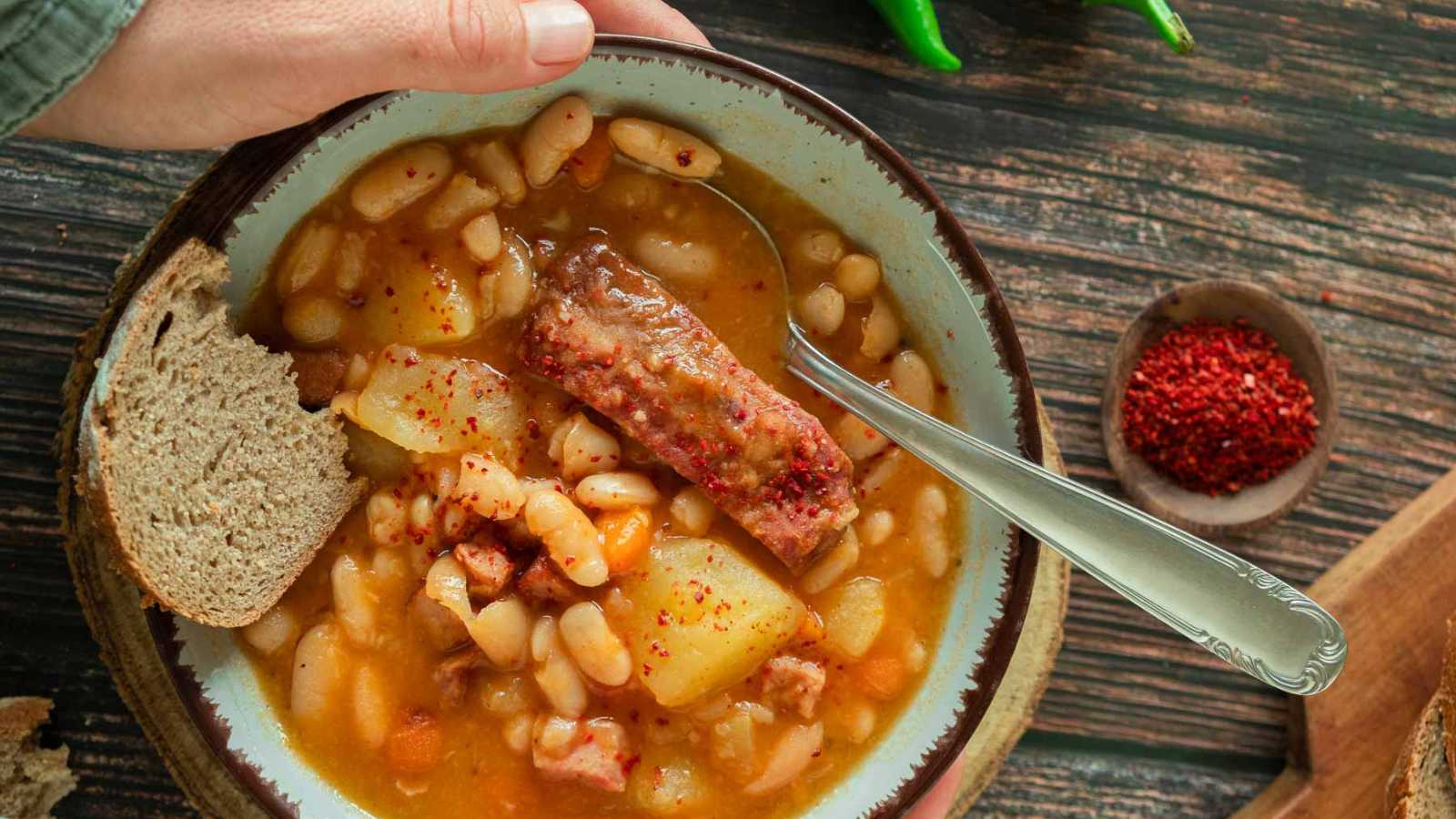 A bowl of Croatian grah with beans and smoked pork ribs.