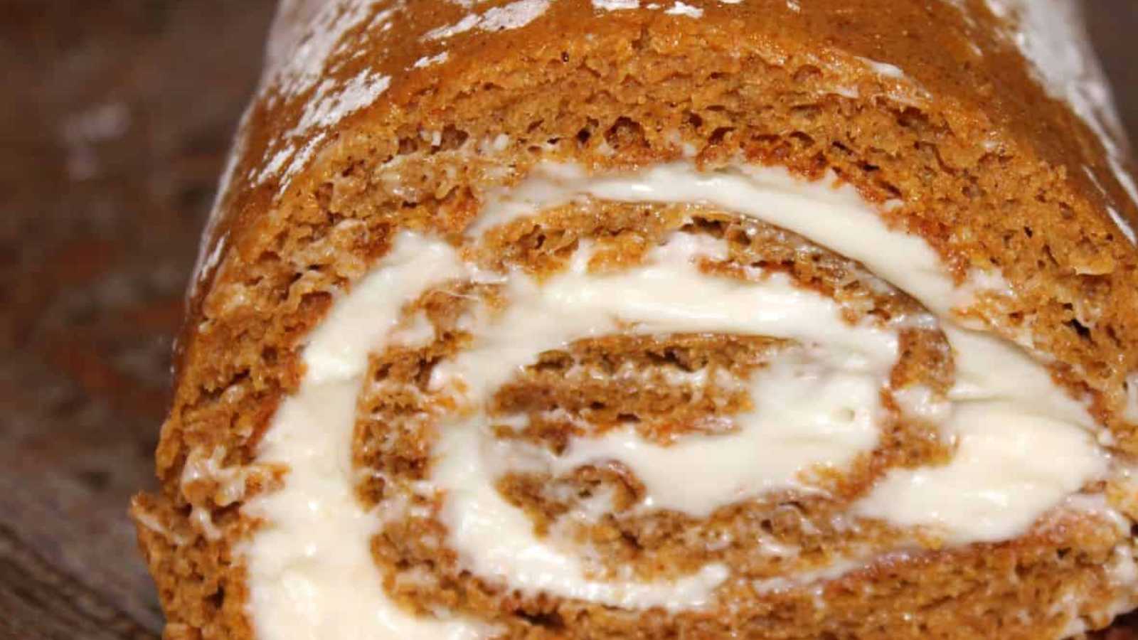 A blend of pumpkin spice cake wrapped around a velvety cream cheese filling, creating a delightful, sweet, and indulgent dessert.