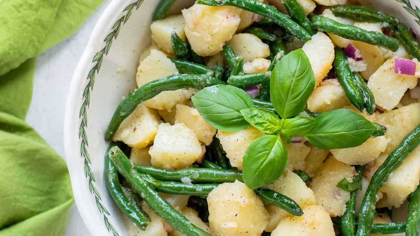 Potato salad with green beans in bowl.