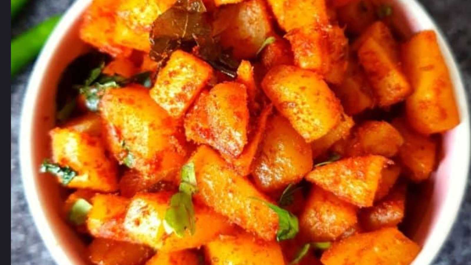 A bowl of fried potatoes seasoned with cumin seeds and aromatic spices.