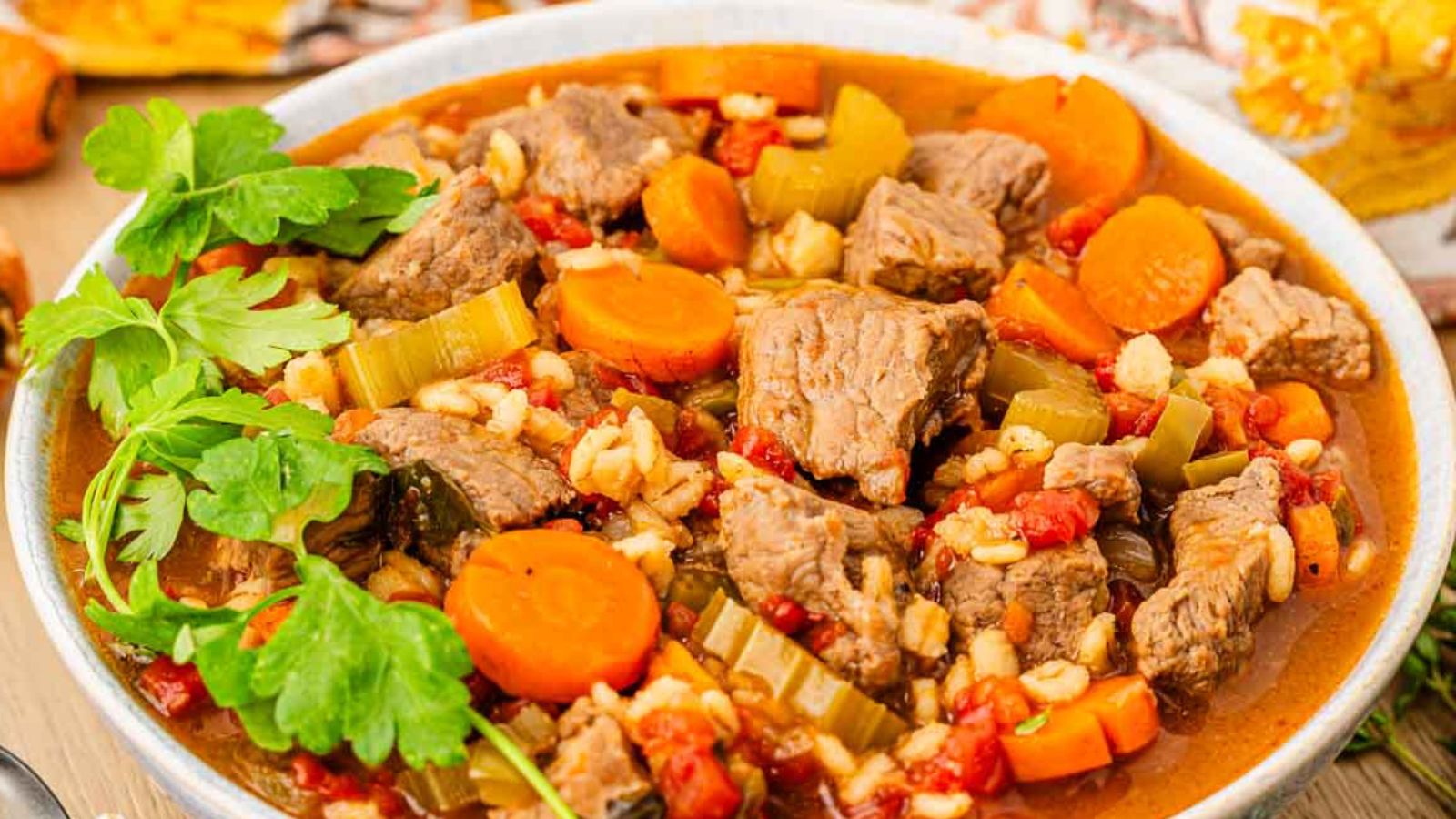 A bowl of barley stew with beef and vegetables.