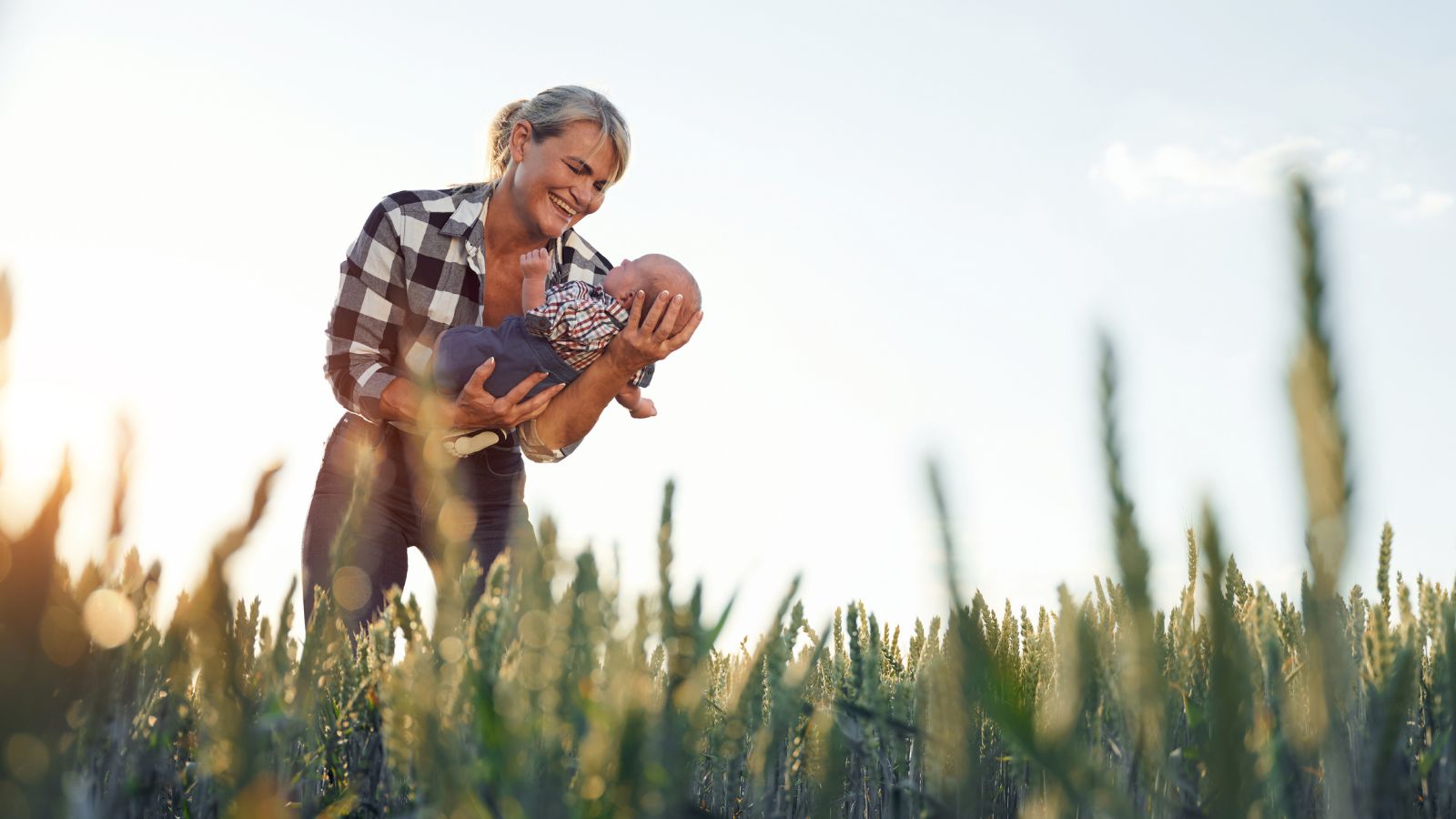 Woman and baby in wheat field.