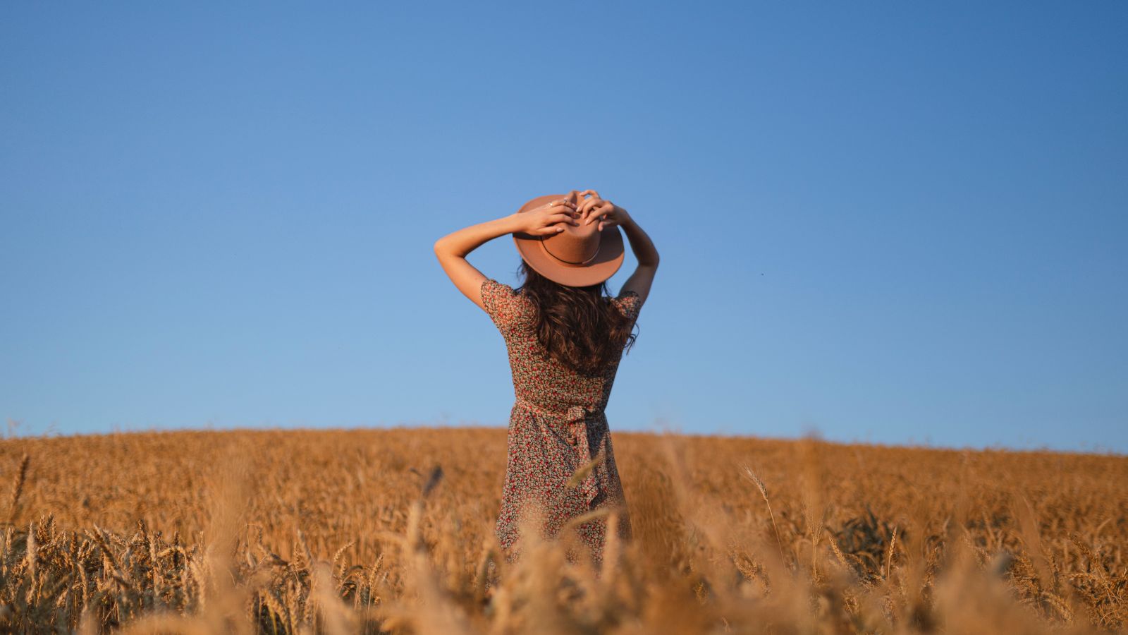 Woman standing in wheat field.