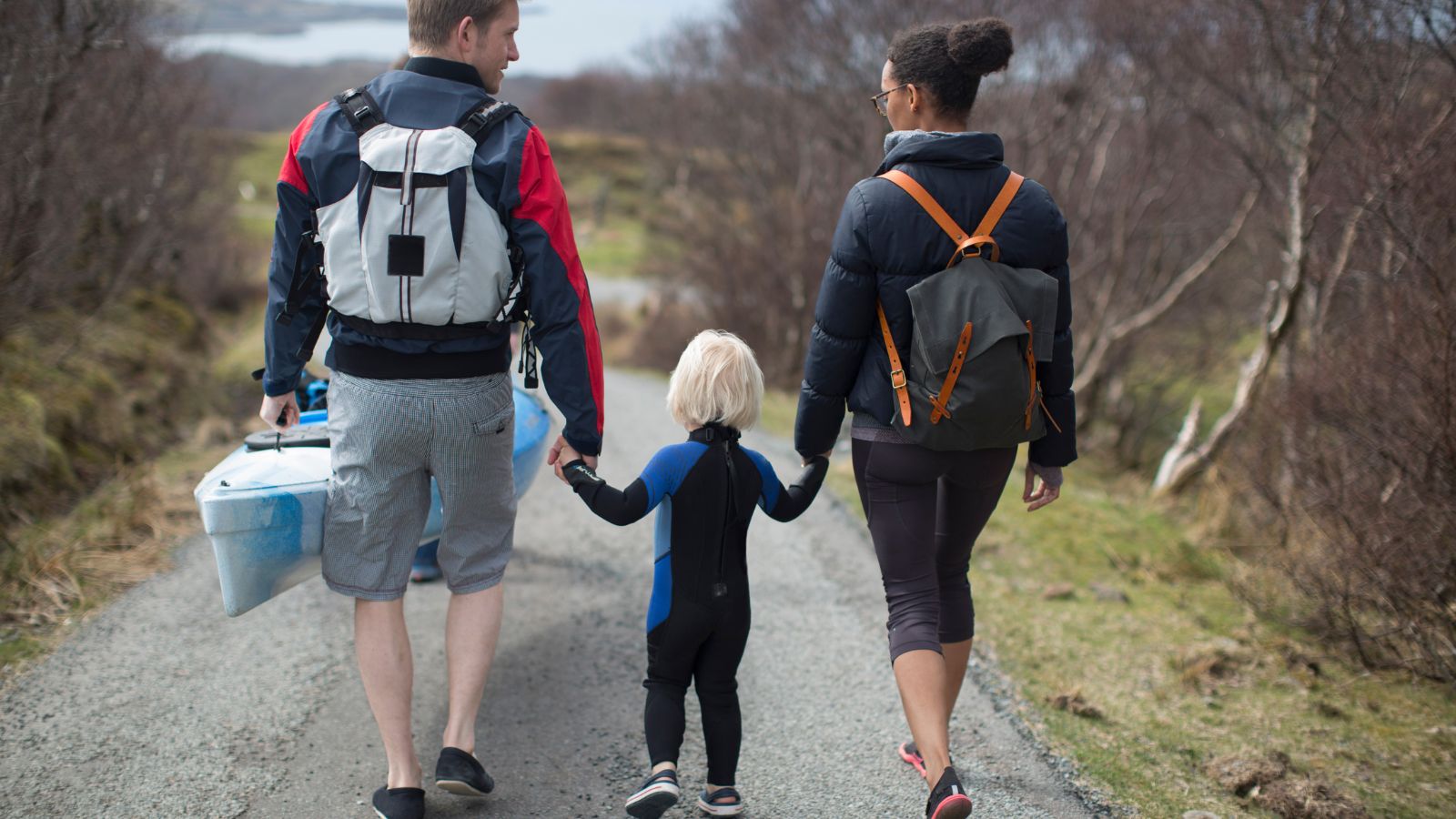 A couple and child walking with boy.