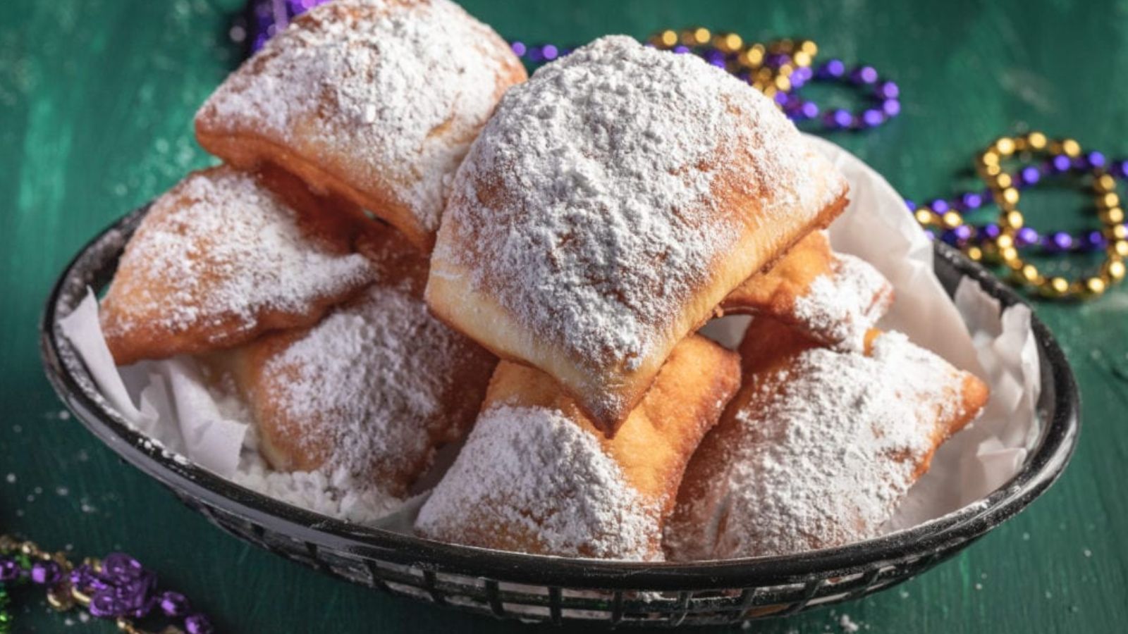 They are deep-fried, similar to doughnuts, but they're square, irresistibly airy, and they're doused in a generous shower of powdered sugar.