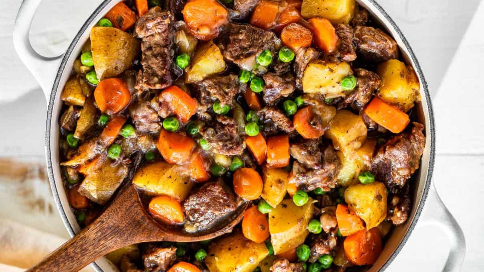 A pot full of super-thick beef stew and vegetables.