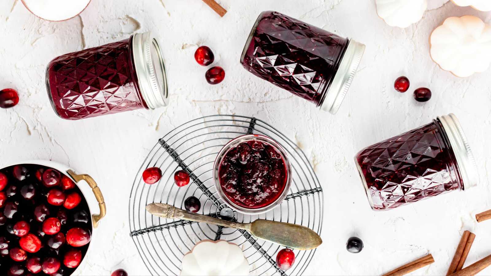 A jar of spiced cranberry jam with a right balance of sweet and tart, with a hint of orange and lots of warm spices.
