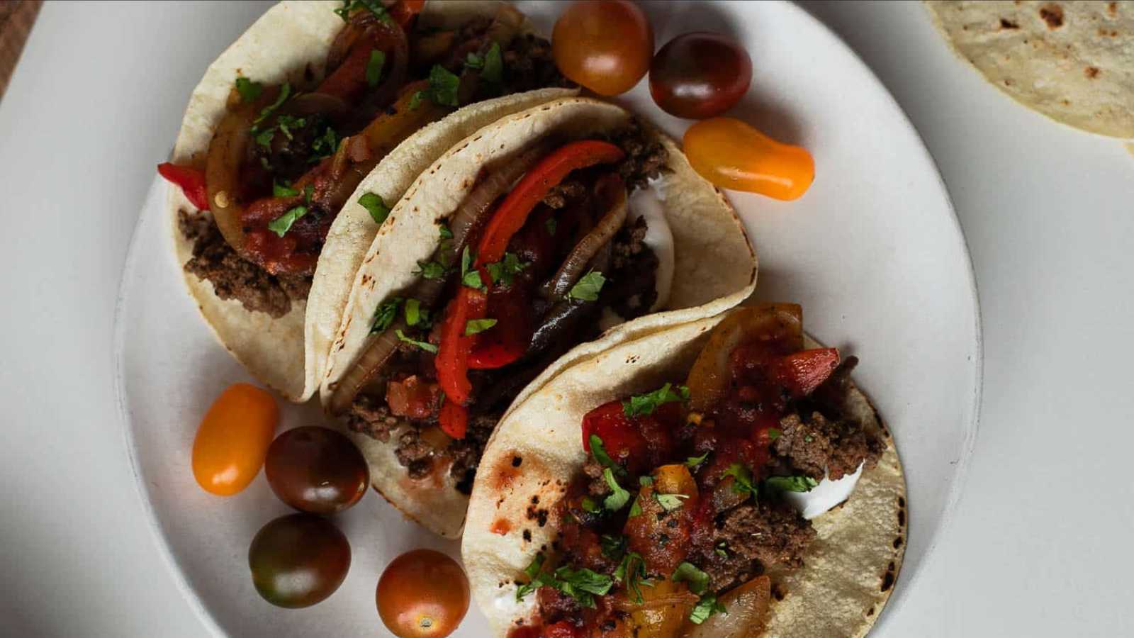A mouthwatering assortment of tacos on a plate.