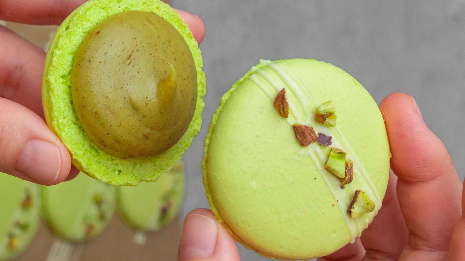 Vibrant green macarons garnished with pistachios.
