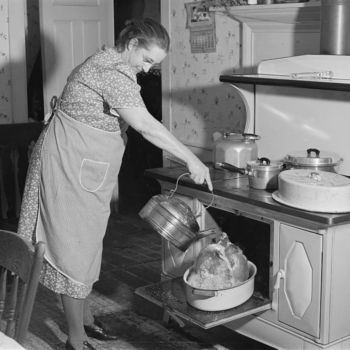 A middle-aged woman pouring water over her turkey.