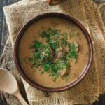 A big bowl of creamy Hungarian mushroom soup with mushrooms and fresh dill.