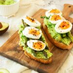 Asparagus toast with eggs and mashed avocado.