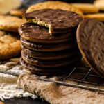 A batch of round cookies made with whole grain fresh milled flour. Some are topped with chocolate.