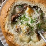 The finished garlic soup served in a bread bowl.