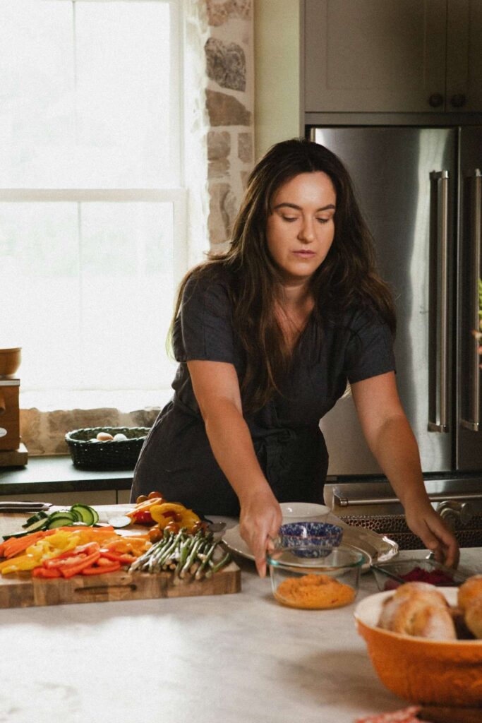 A photo of Jana Dziak, founder of The Peasant's Daughter and Heritage Kitchen Revival standing in her kitchen.