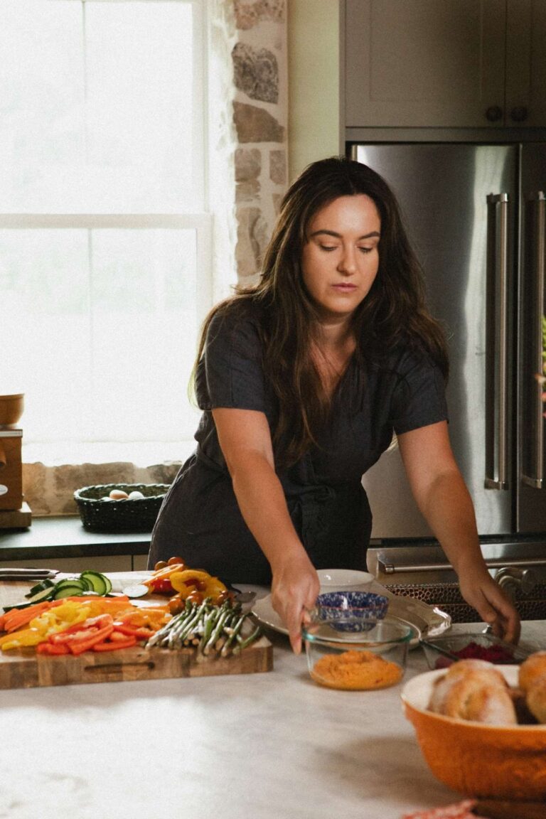 A photo of Jana Dziak, founder of The Peasant's Daughter and Heritage Kitchen Revival standing in her kitchen.