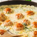Chicken ricotta meatballs in a spinach Alfredo sauce.