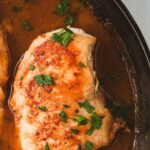 Close up of a chicken breast in coconut lime sauce.