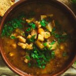 A bowl of beef tripe soup with loads of vegetables.