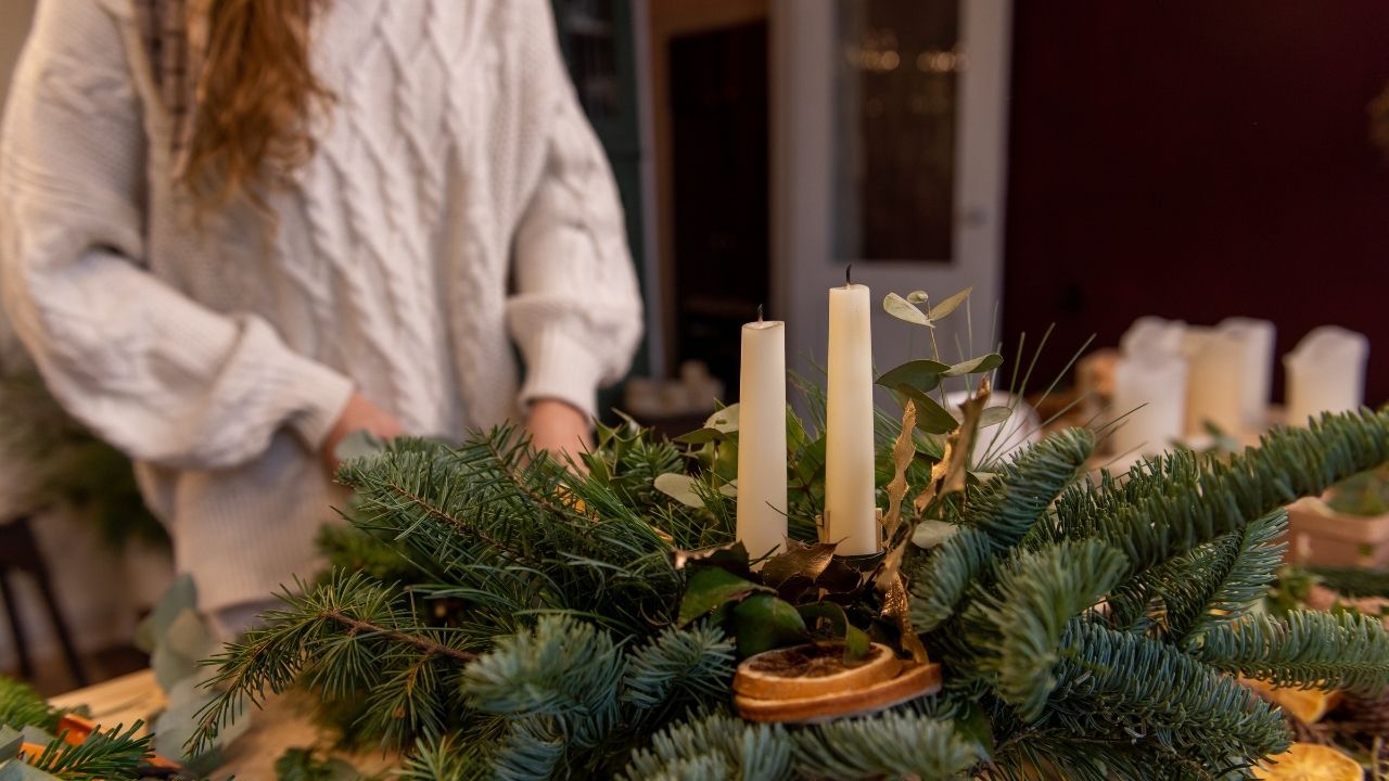 Woman lighting candles.