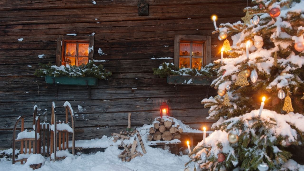 A snowy winter cabin at Christmas time.