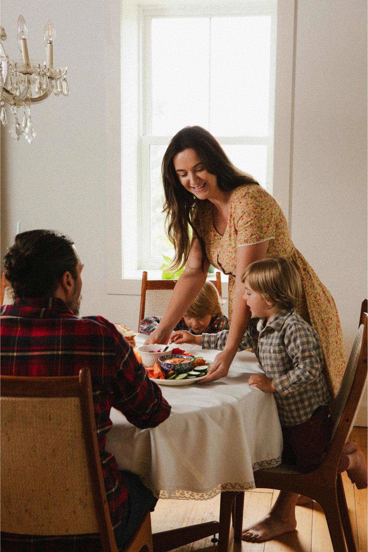 A mother serves her family a meal.