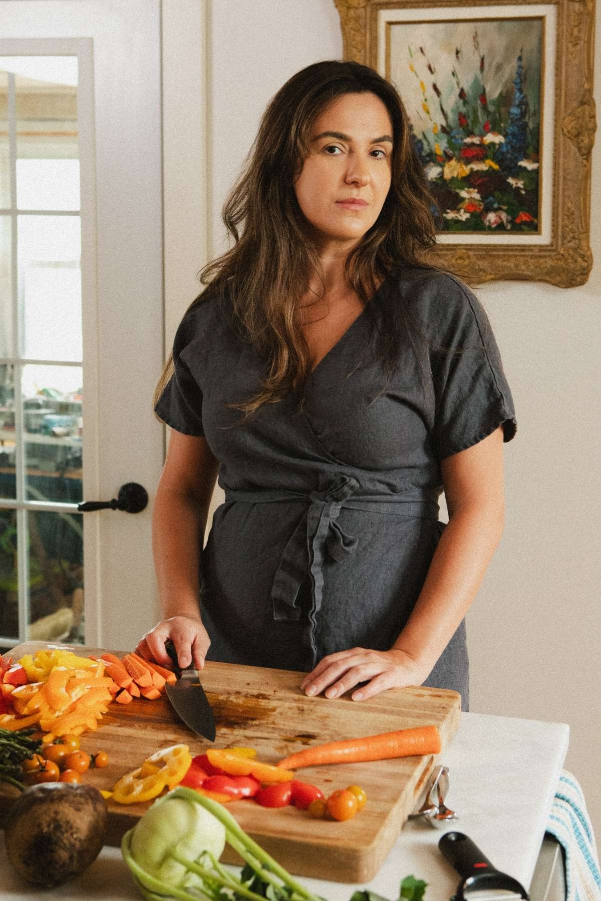 A photo of Jana Dziak, founder of The Peasant's Daughter and Heritage Kitchen Revival standing in her kitchen.
