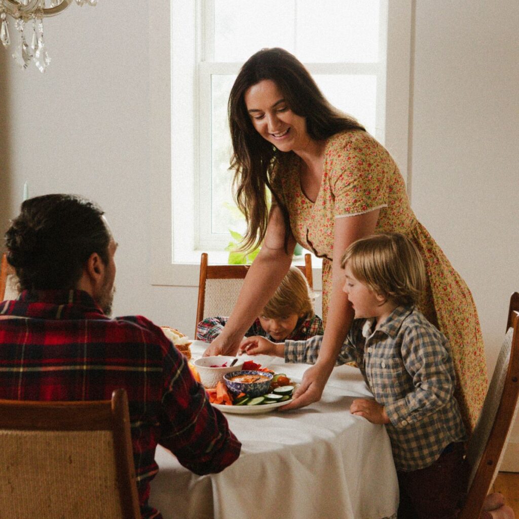 A mother serves her family a meal.