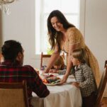 A mother serves her family a meal.