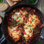 Cheesy and saucy German Gypsy schnitzel or zigeunerschnitzel on a cast iron skillet.