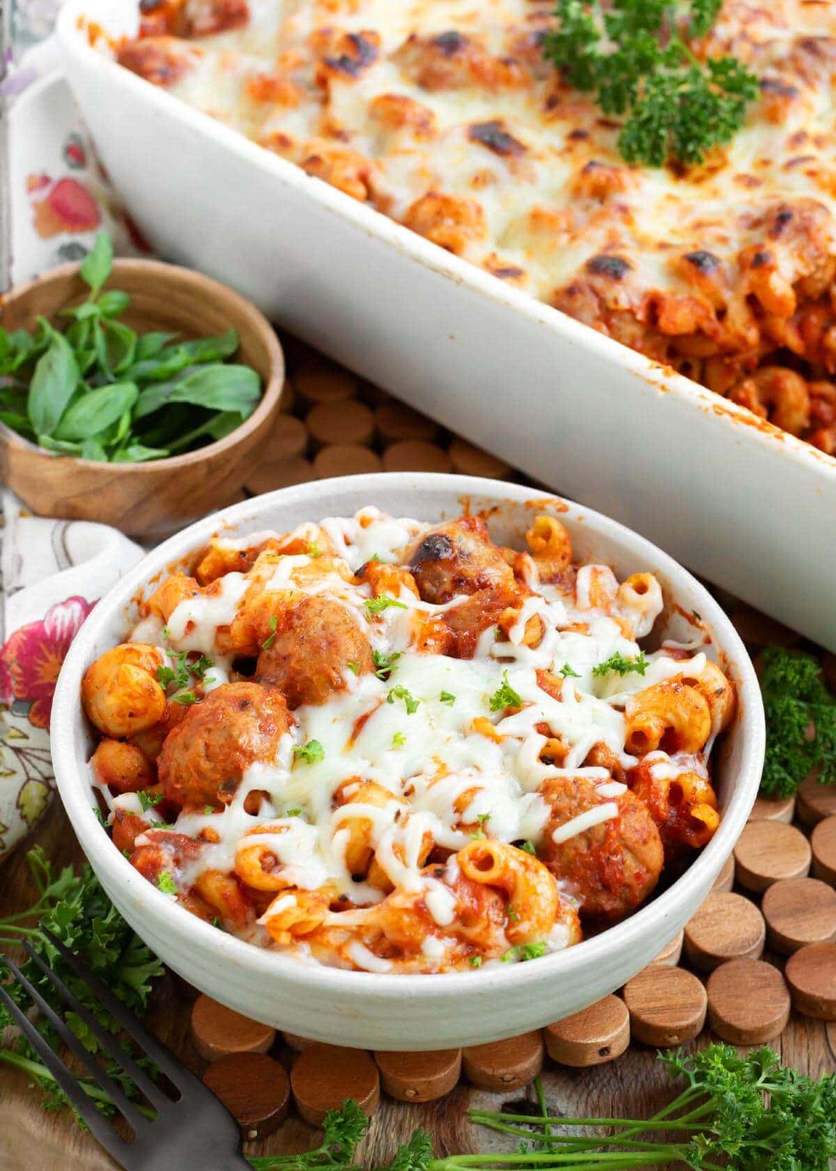 Baked pasta and meatballs covered in melted cheese and sauce.