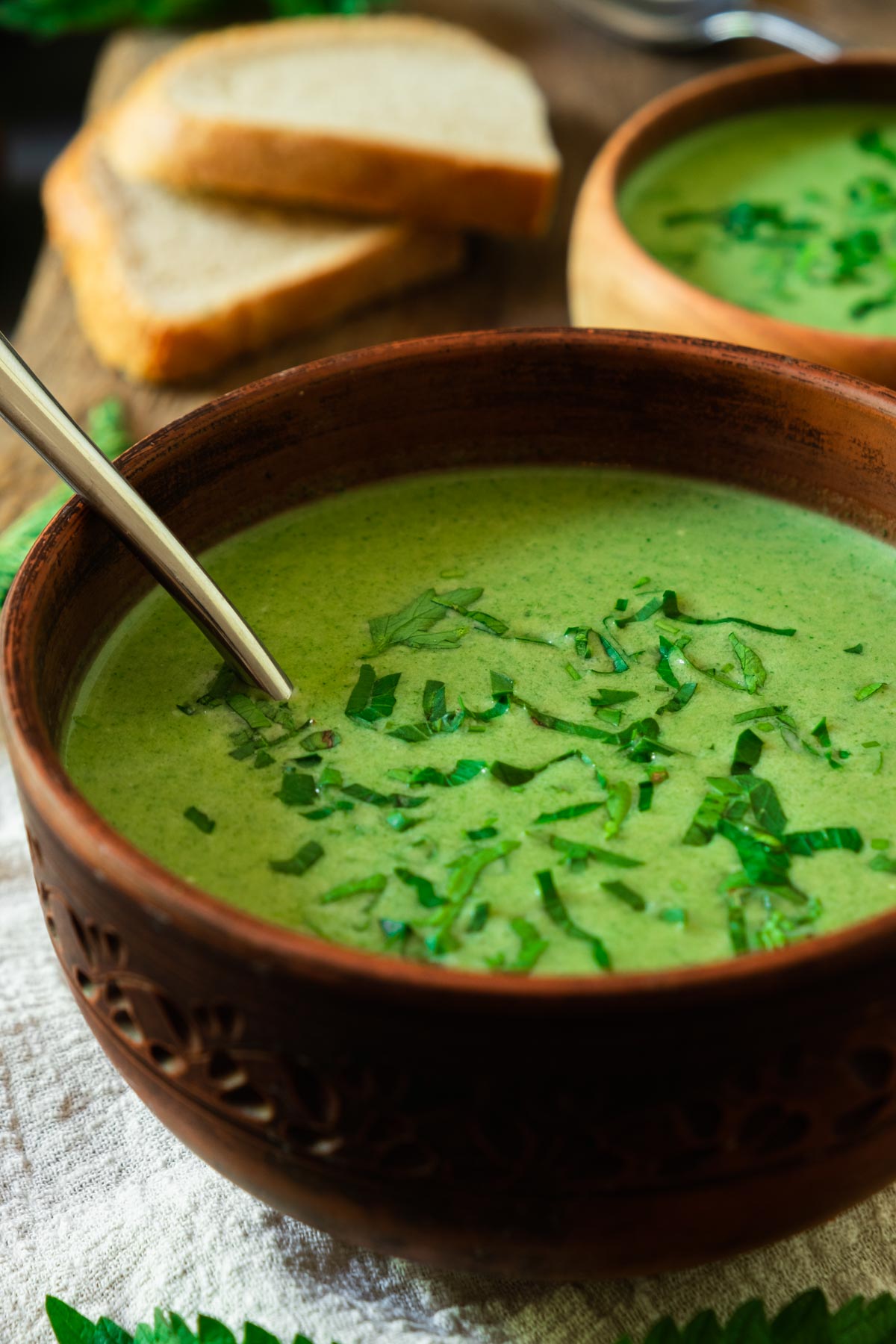 A bowl of bright green stinging nettle soup.