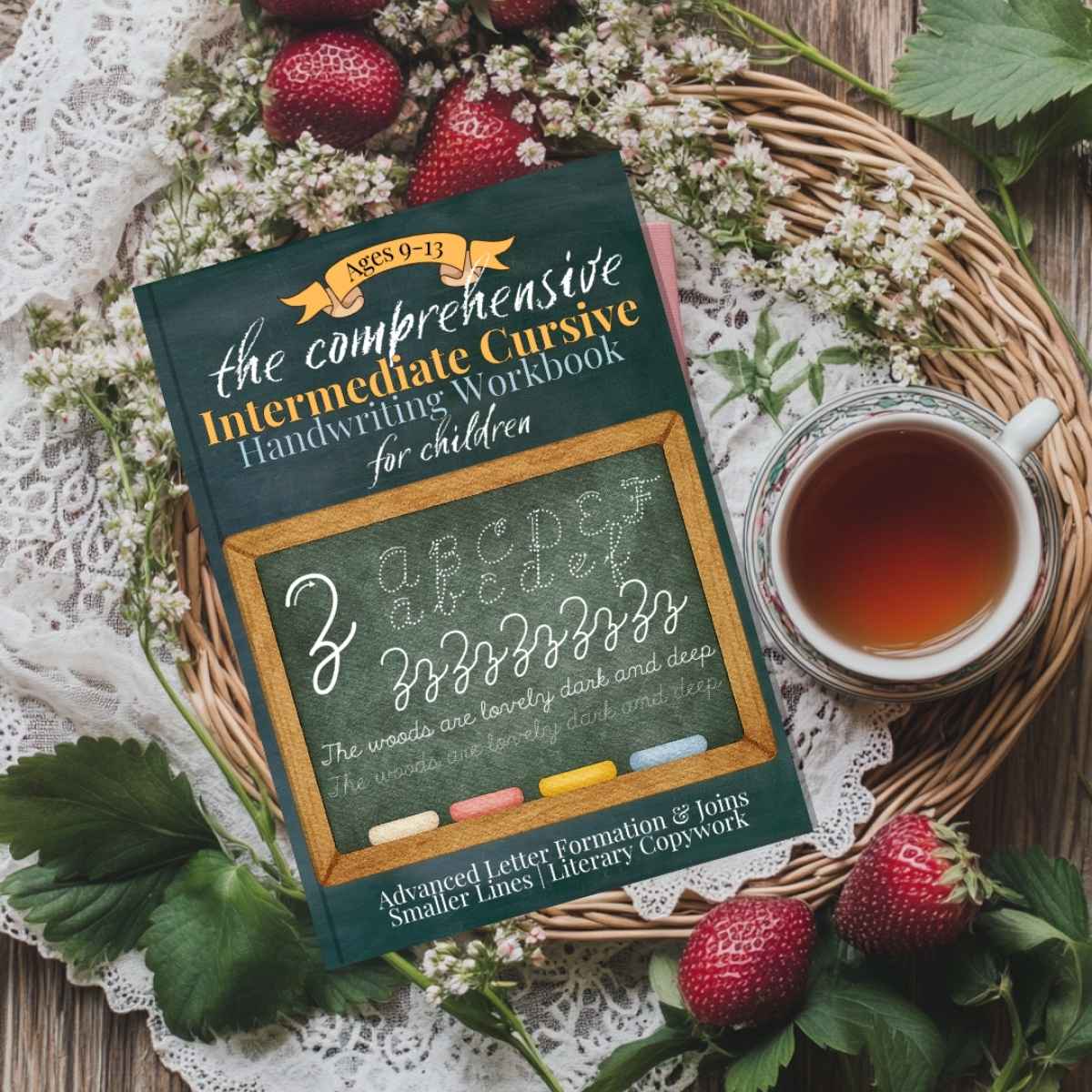 The Intermediate Cursive Handwriting Workbook for Kids book by Jana Dziak next to a teatime.