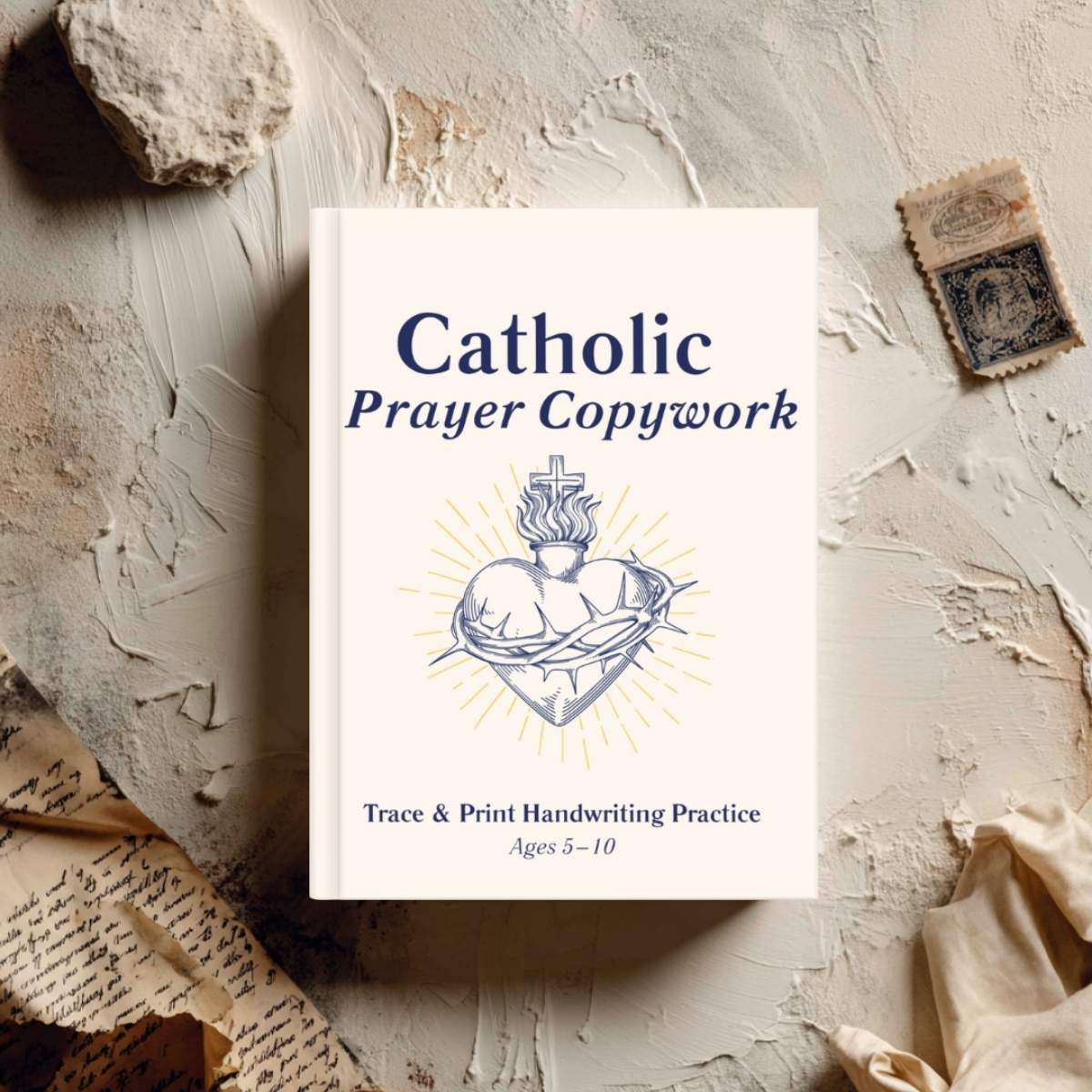 A copy of 'Catholic Prayer Copywork: Trace and Print Handwriting Practice for Kids' on a table.