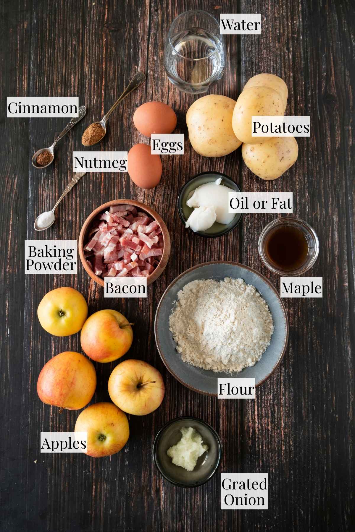 An overhead shot showing all of the ingredients needed to make these German potato pancakes and apple sauce.