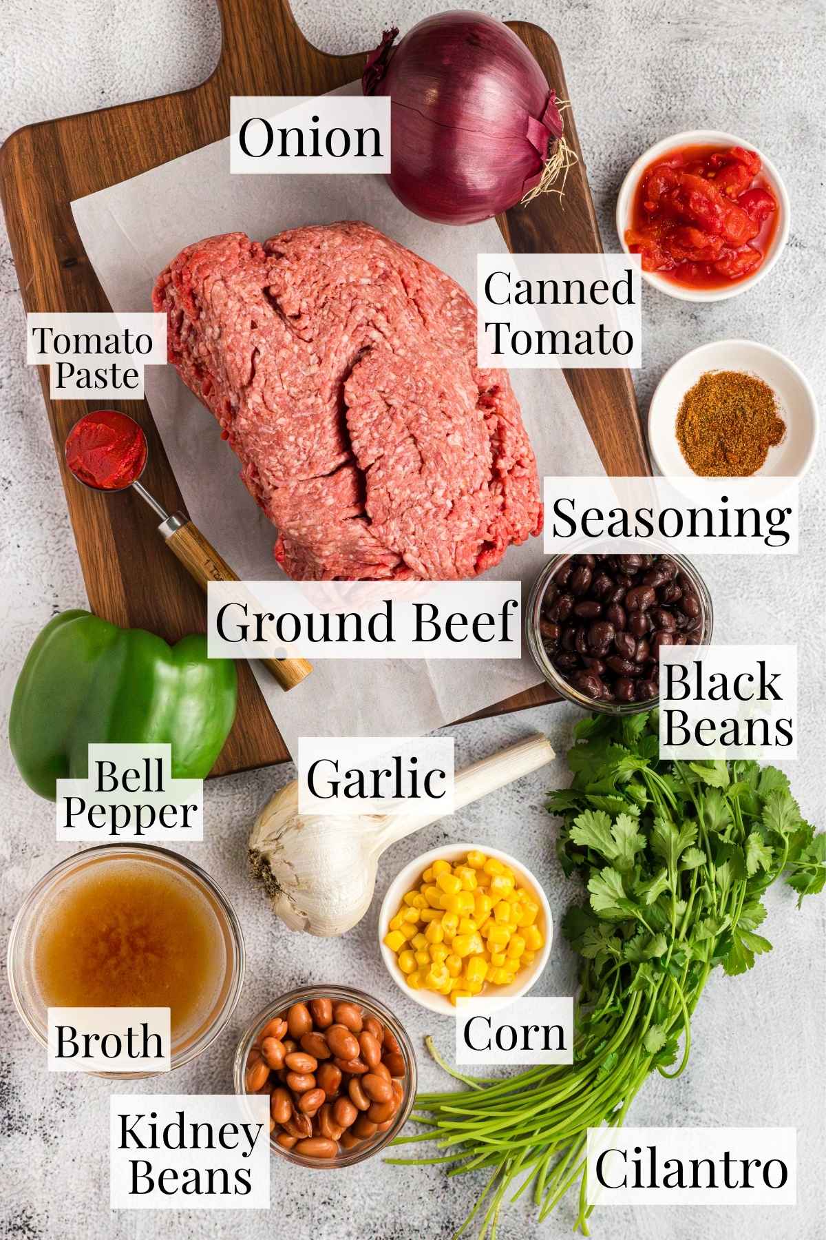 All of the raw ingredients needed to make this crock pot chili recipe with beans and ground beef.