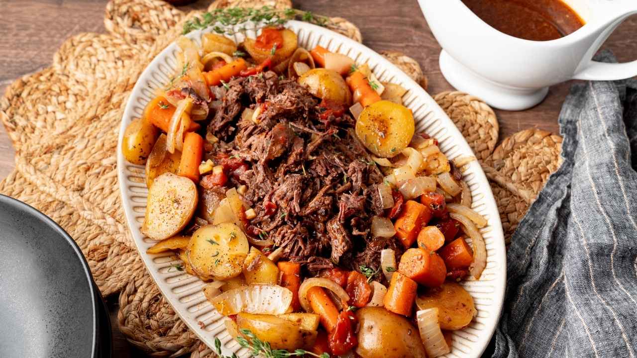 A platter of the slow cooked beef and vegetables ready to serve at the dinner table.